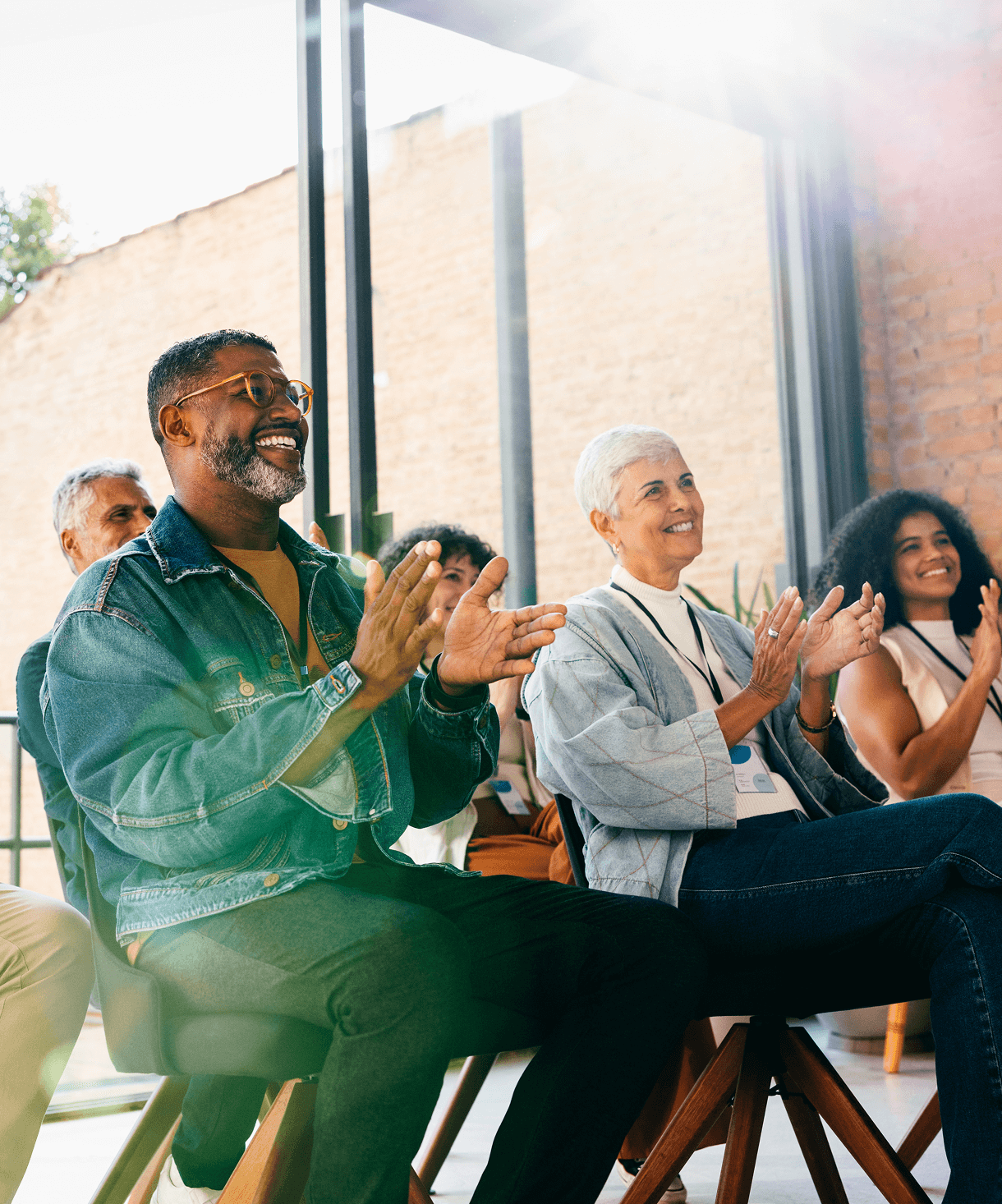 People clapping in a bright room.